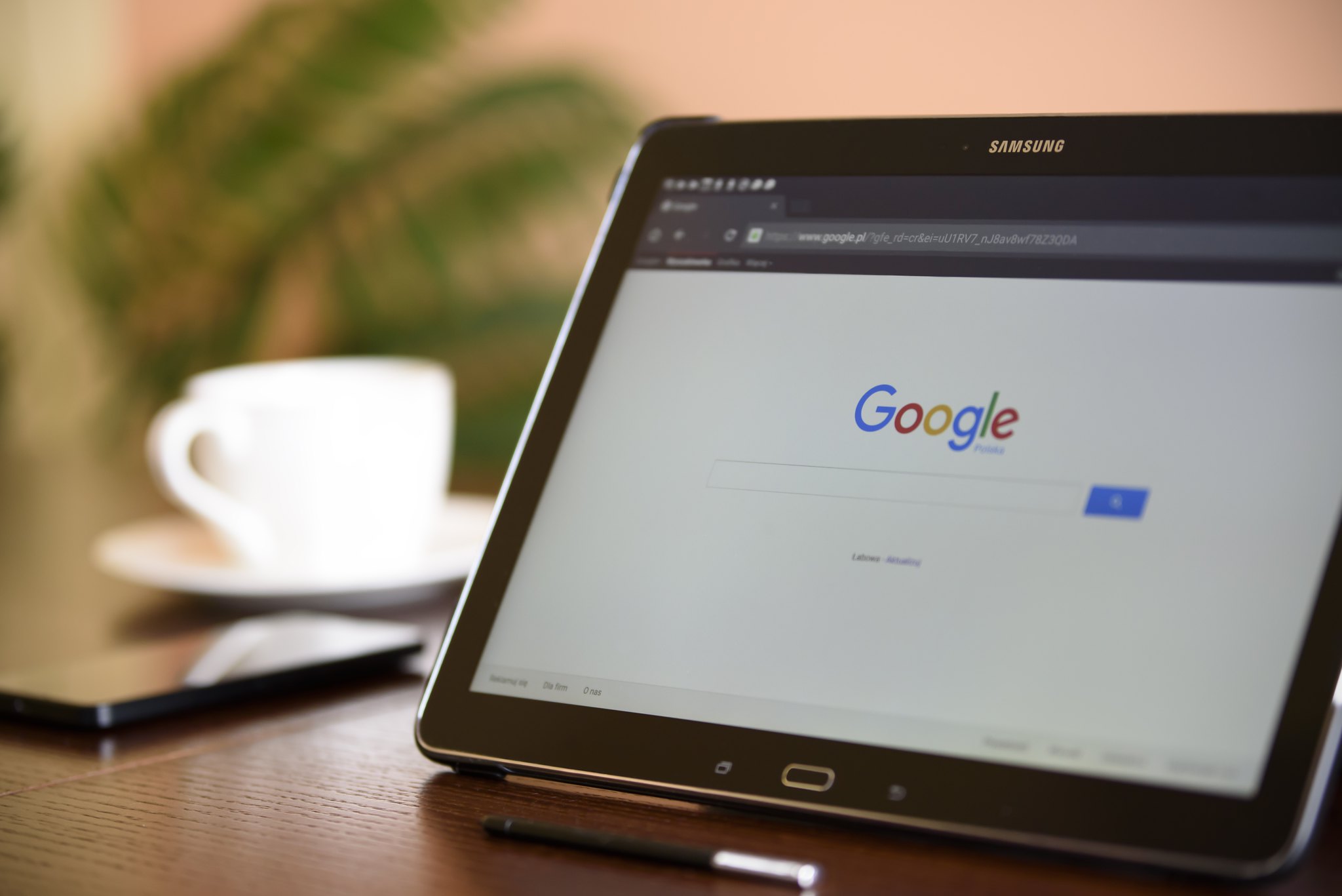 Marketing Google homepage on tablet and cup of coffee