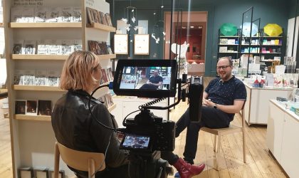 eCommerce and Merchandising Woman interviewing man on camera