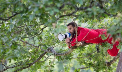 Man in tree using loudspeaker