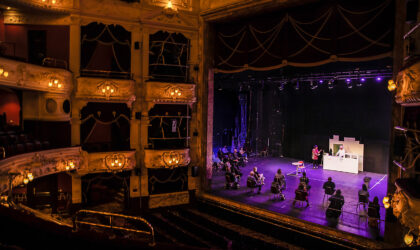 Performers on theatre stage in empty theatre