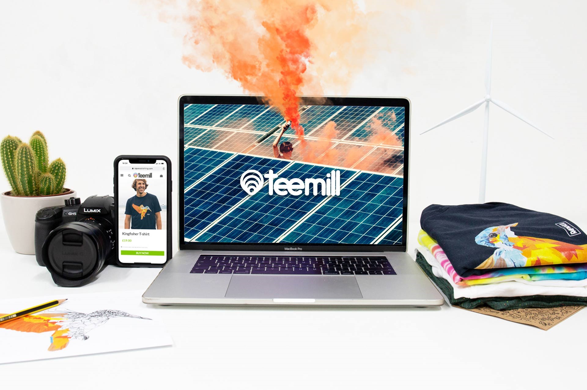 Computer featuring Teemill logo, t shirts, mobile phone and camera