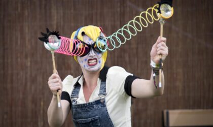 Performer with googly eyes on sticks