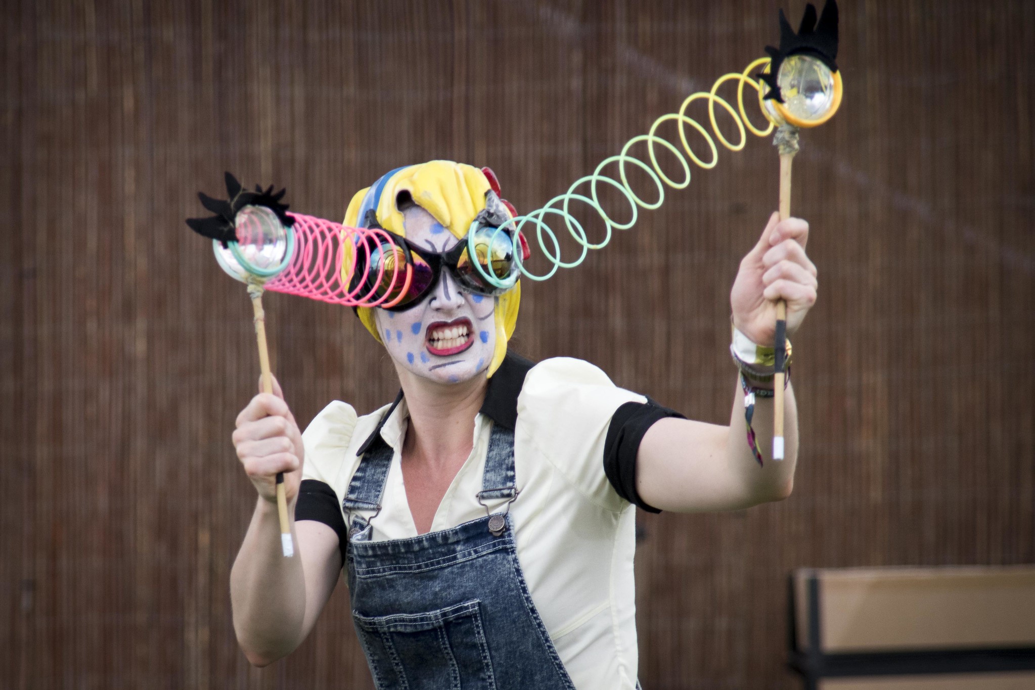 Performer with googly eyes on sticks