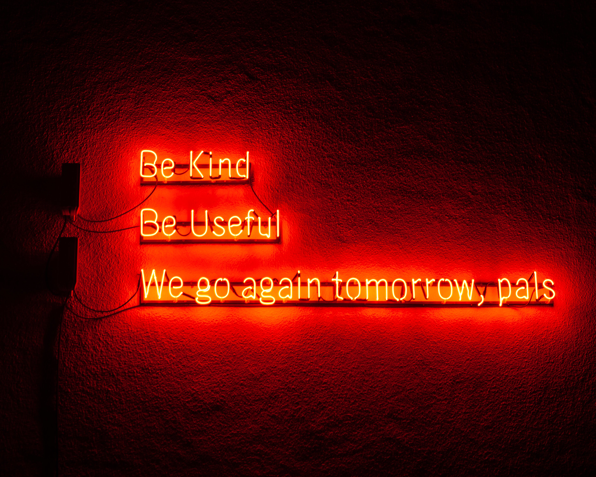 Lines of text displayed in lights reading 'be kind, be useful, we go again tomorrow, pals'