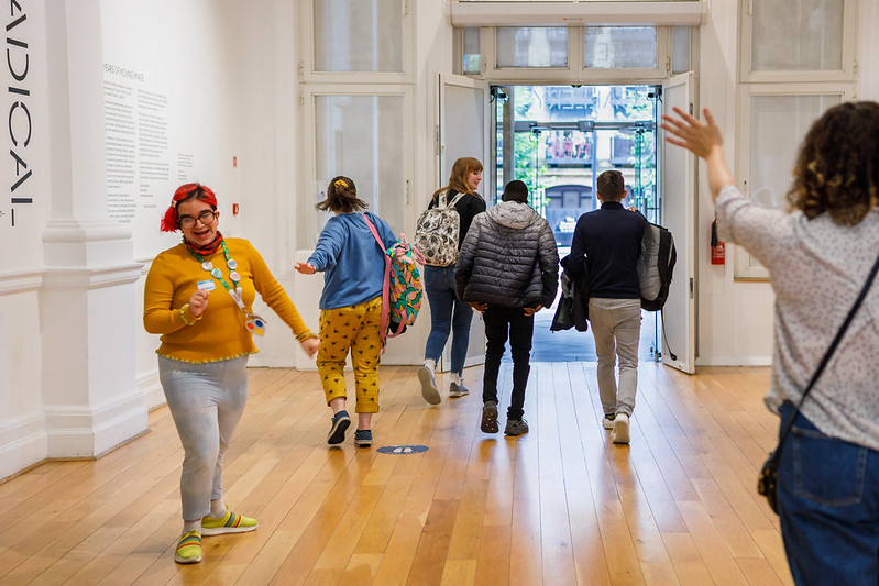 Image of group of young people leaving what looks like an art gallery
