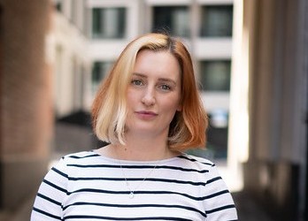 Tech Champion Katy Farrell wearing black and white striped top and black trousers.