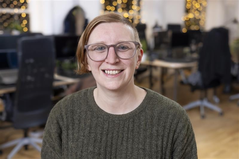 Tech Champion Karys Moffat smiling, wearing glasses.