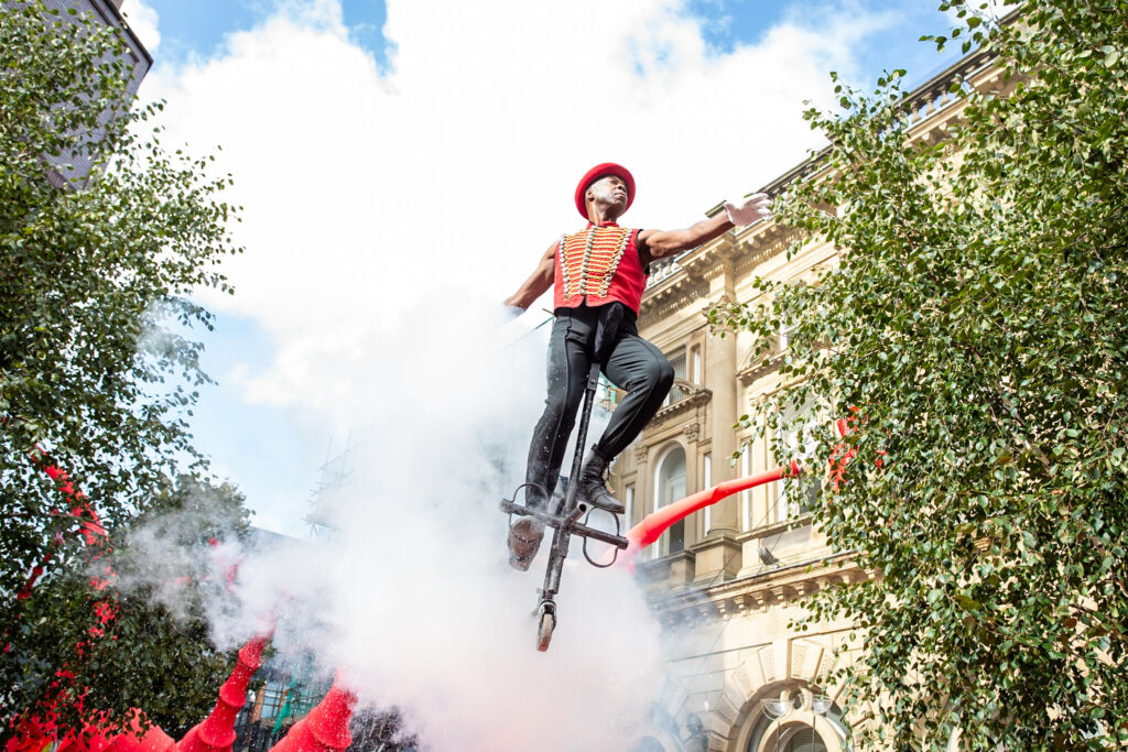 A person can be seen flying in the air on a pogo stick.