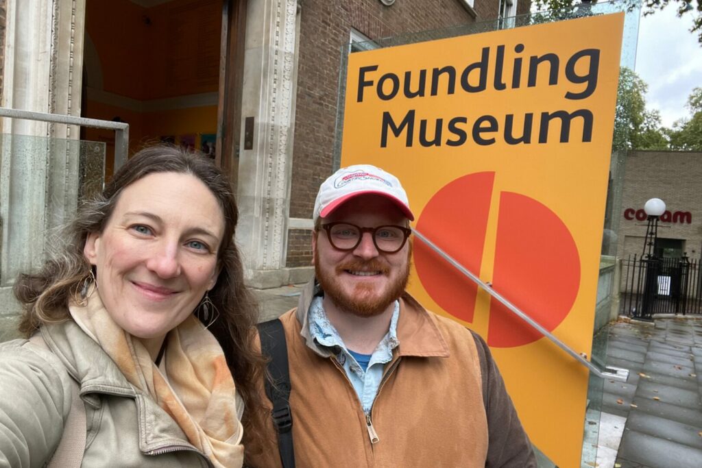 Tech Champions Katherina and Adam take a selfie outside the sign for the 'Foundling Museum'.